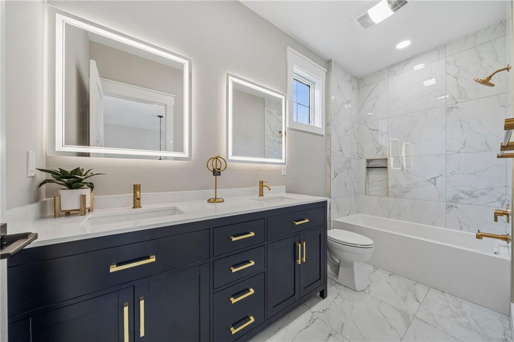 224 Bunger Street Ligonier, PA 15658 - Photo 34 of 50 a bathroom with a granite countertop sink toilet mirror and bathtub