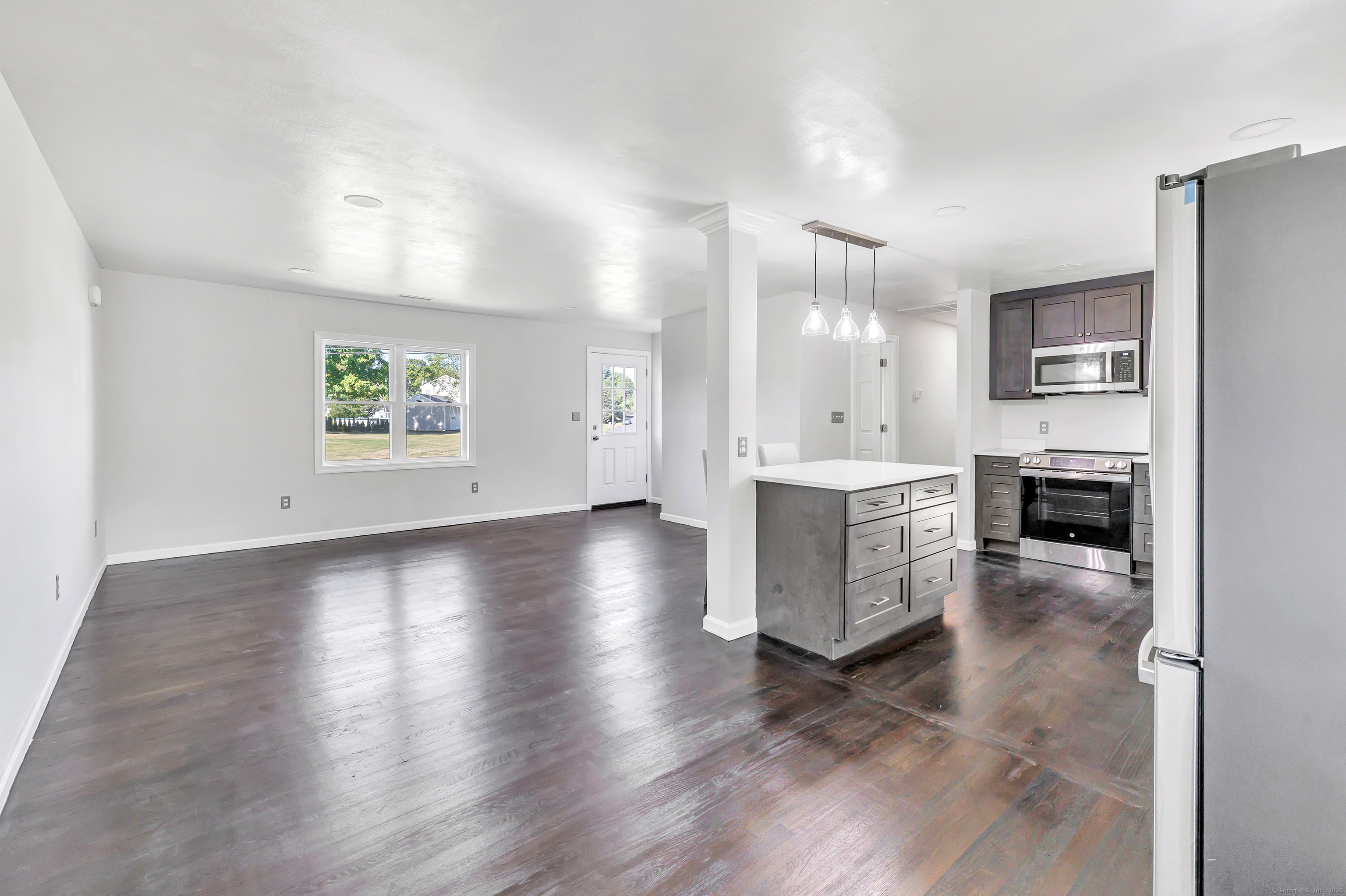 38 Pine River Road North Haven, CT 06473 - Photo 15 of 38 an empty room with a fireplace and wooden floor