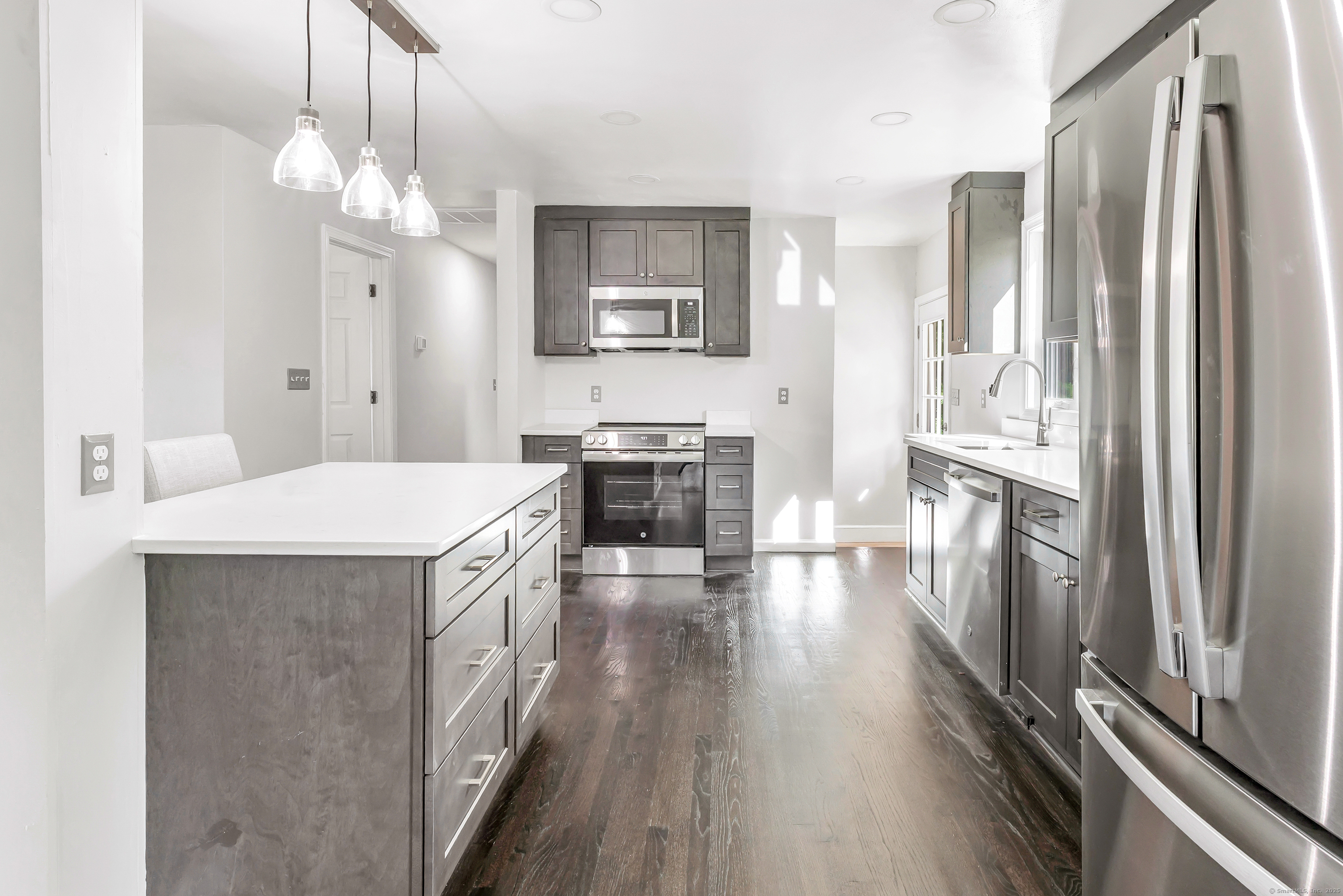 38 Pine River Road North Haven, CT 06473 - Photo 16 of 38 a kitchen with stainless steel appliances a stove a refrigerator a sink a oven with wooden floor