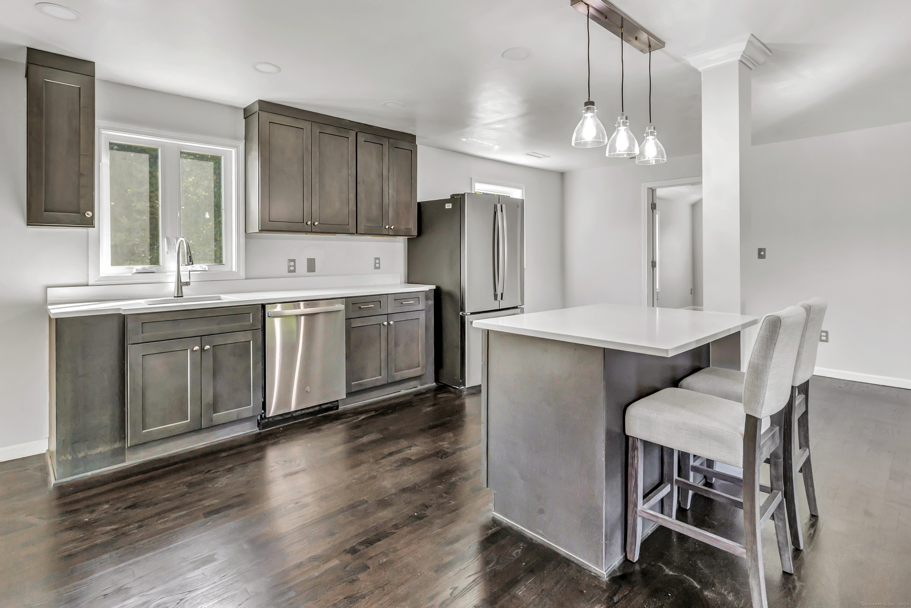 38 Pine River Road North Haven, CT 06473 - Photo 19 of 38 a kitchen with a table chairs refrigerator and microwave
