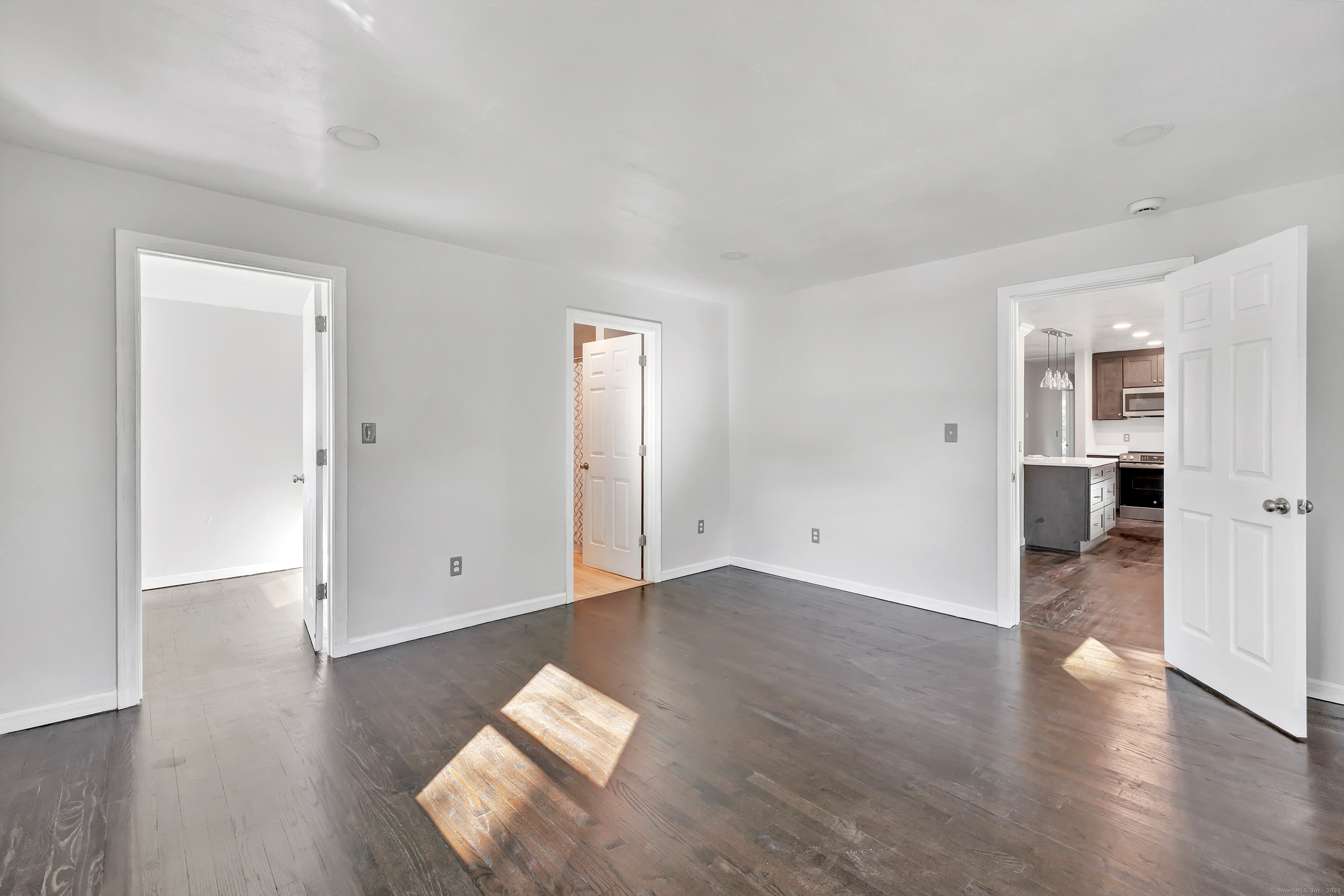 38 Pine River Road North Haven, CT 06473 - Photo 23 of 38 an empty room with wooden floor & windows and bathroom