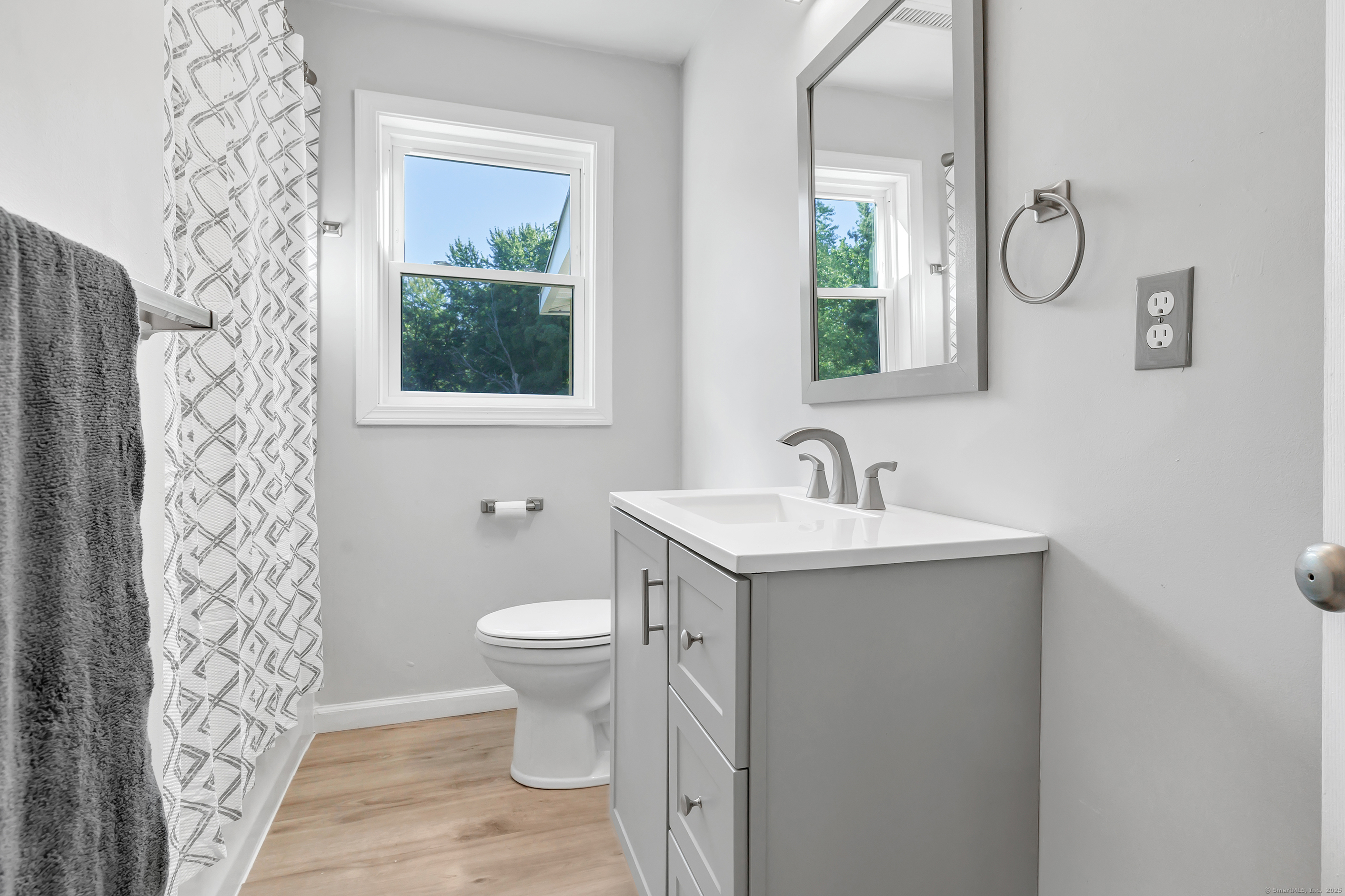 38 Pine River Road North Haven, CT 06473 - Photo 31 of 38 a bathroom with a granite countertop sink a toilet and a mirror