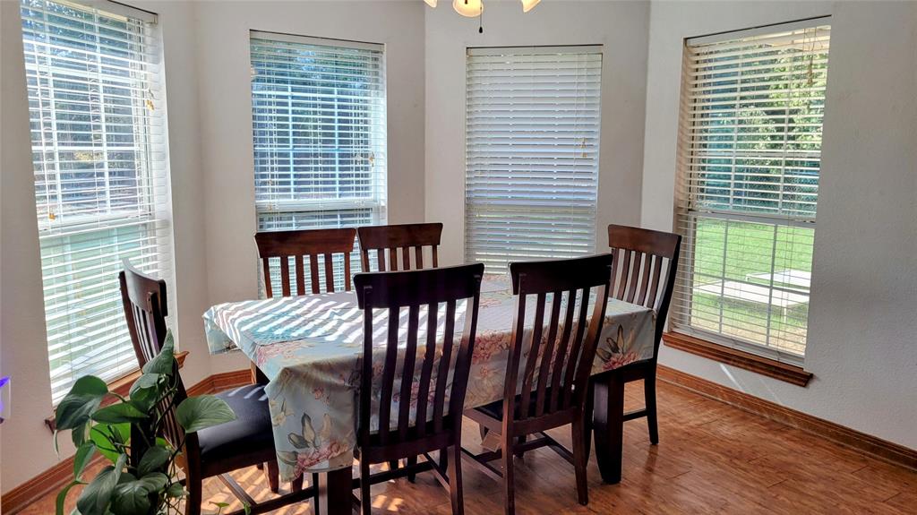 3164 Clater Powell Road Waco, TX 76705 - Photo 22 of 40 a view of a dining room with furniture and wooden floor