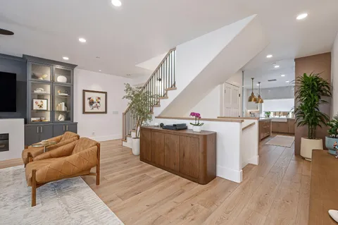 a living room with furniture and a kitchen view