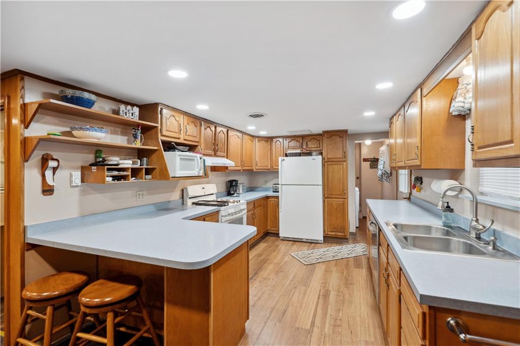 750 Lake Road Addison, PA 15411 - Photo 23 of 44 a kitchen with stainless steel appliances granite countertop a sink stove and refrigerator