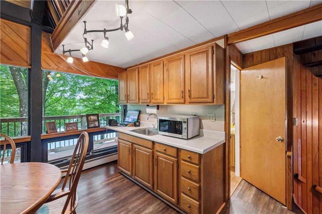 750 Lake Road Addison, PA 15411 - Photo 30 of 44 a kitchen with stainless steel appliances granite countertop a refrigerator a sink dishwasher a stove and white countertops with wooden floor