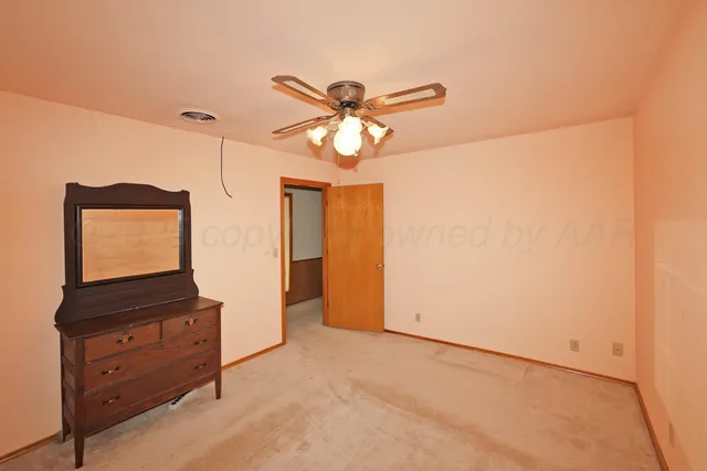 a view of a hallway with a dresser and chandelier