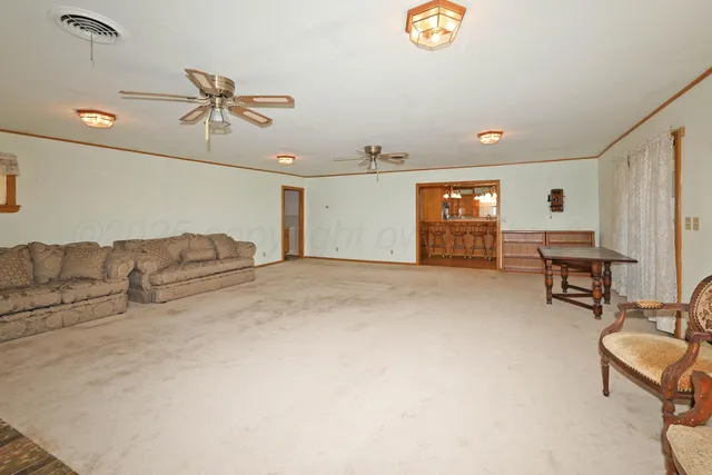 a living room with furniture and a projector screen