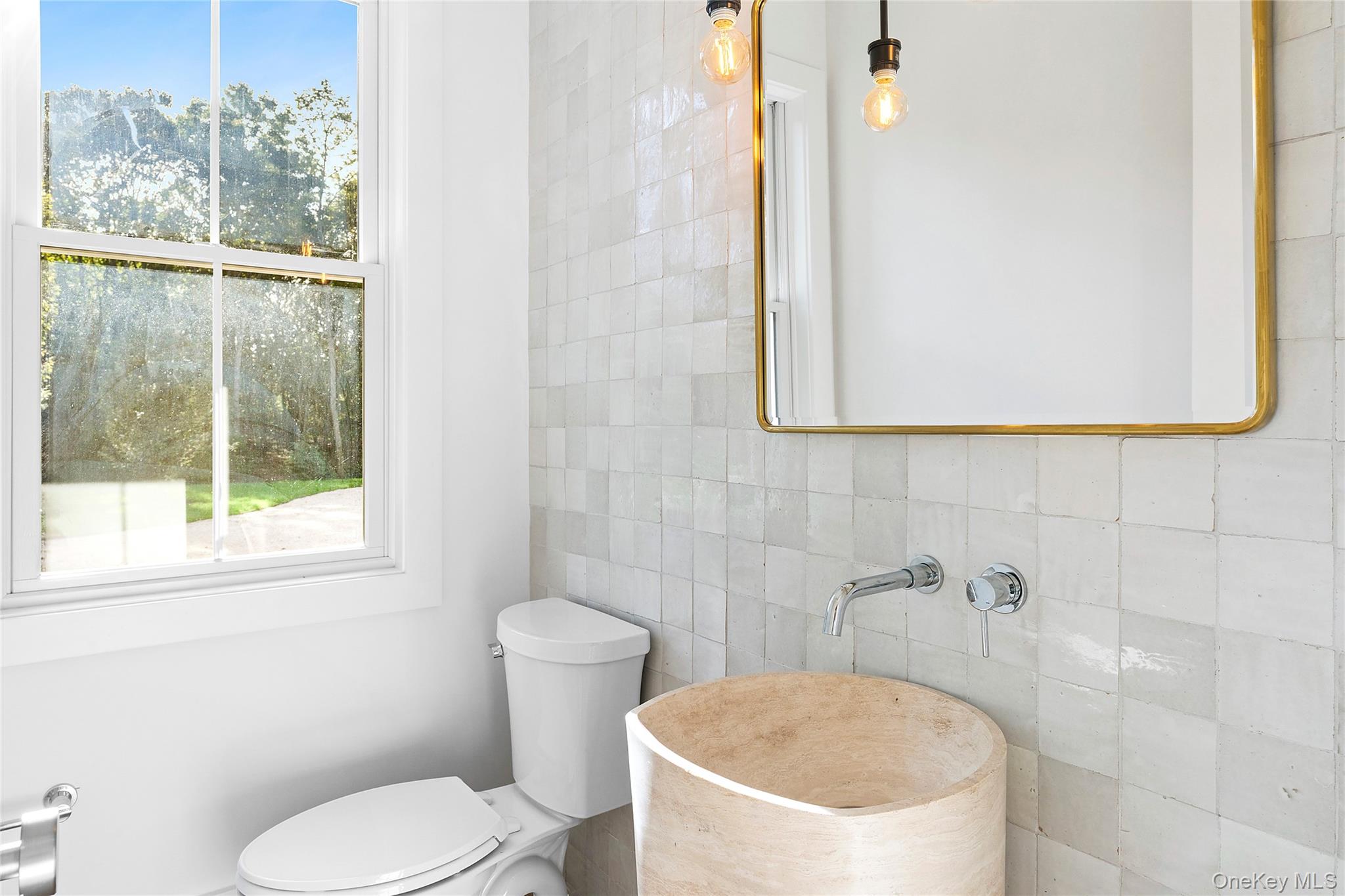 5697 Westphalia Road Mattituck, NY 11952 - Photo 17 of 28 a white toilet sitting next to a bathroom sink