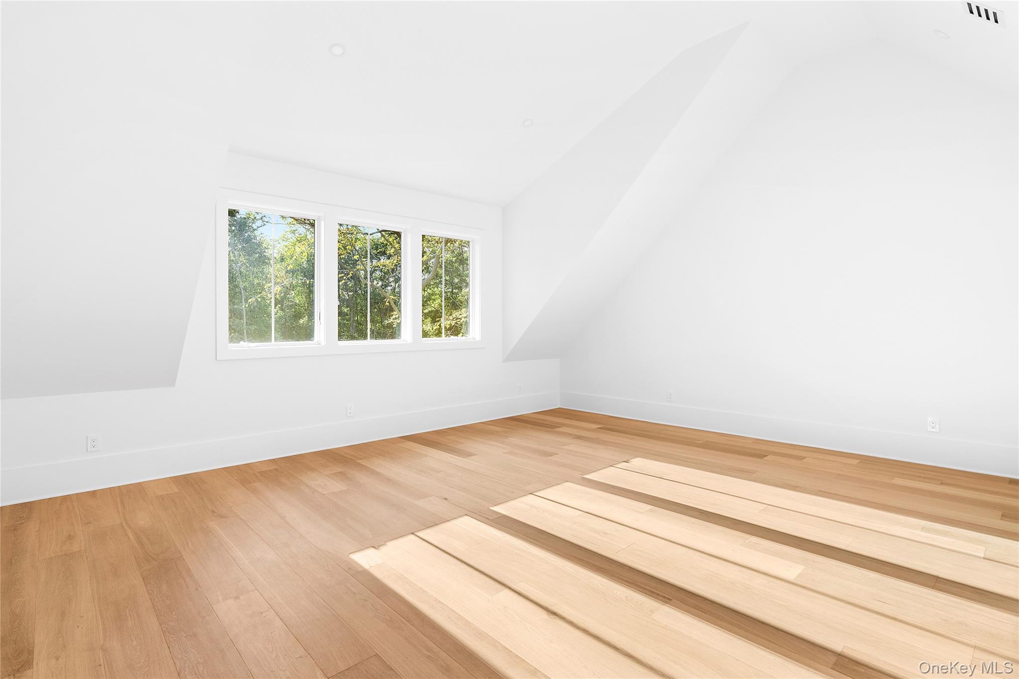 5697 Westphalia Road Mattituck, NY 11952 - Photo 18 of 28 a view of an empty room with wooden floor and a window