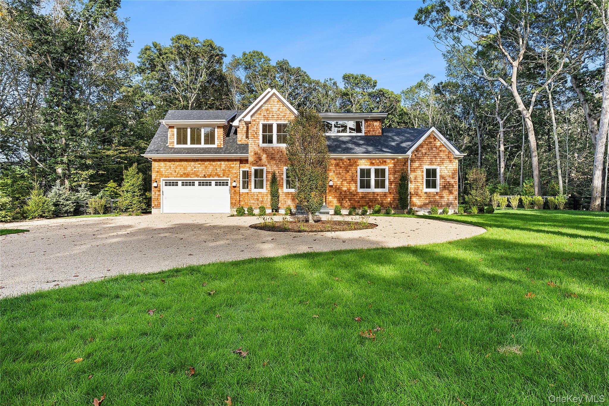 5697 Westphalia Road Mattituck, NY 11952 - Photo 2 of 28 a front view of a house with a yard
