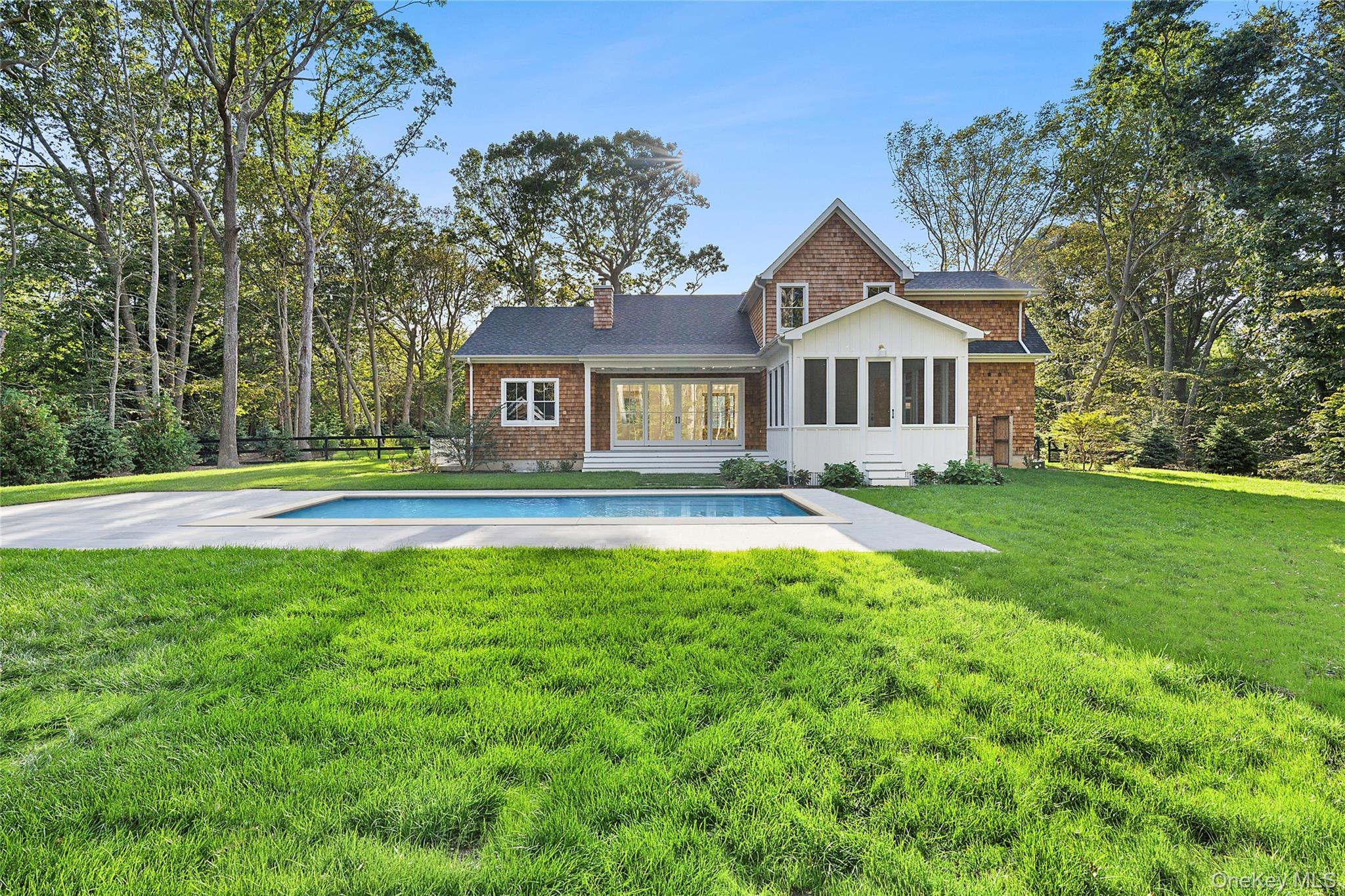 5697 Westphalia Road Mattituck, NY 11952 - Photo 3 of 28 a front view of a house with a yard and trees