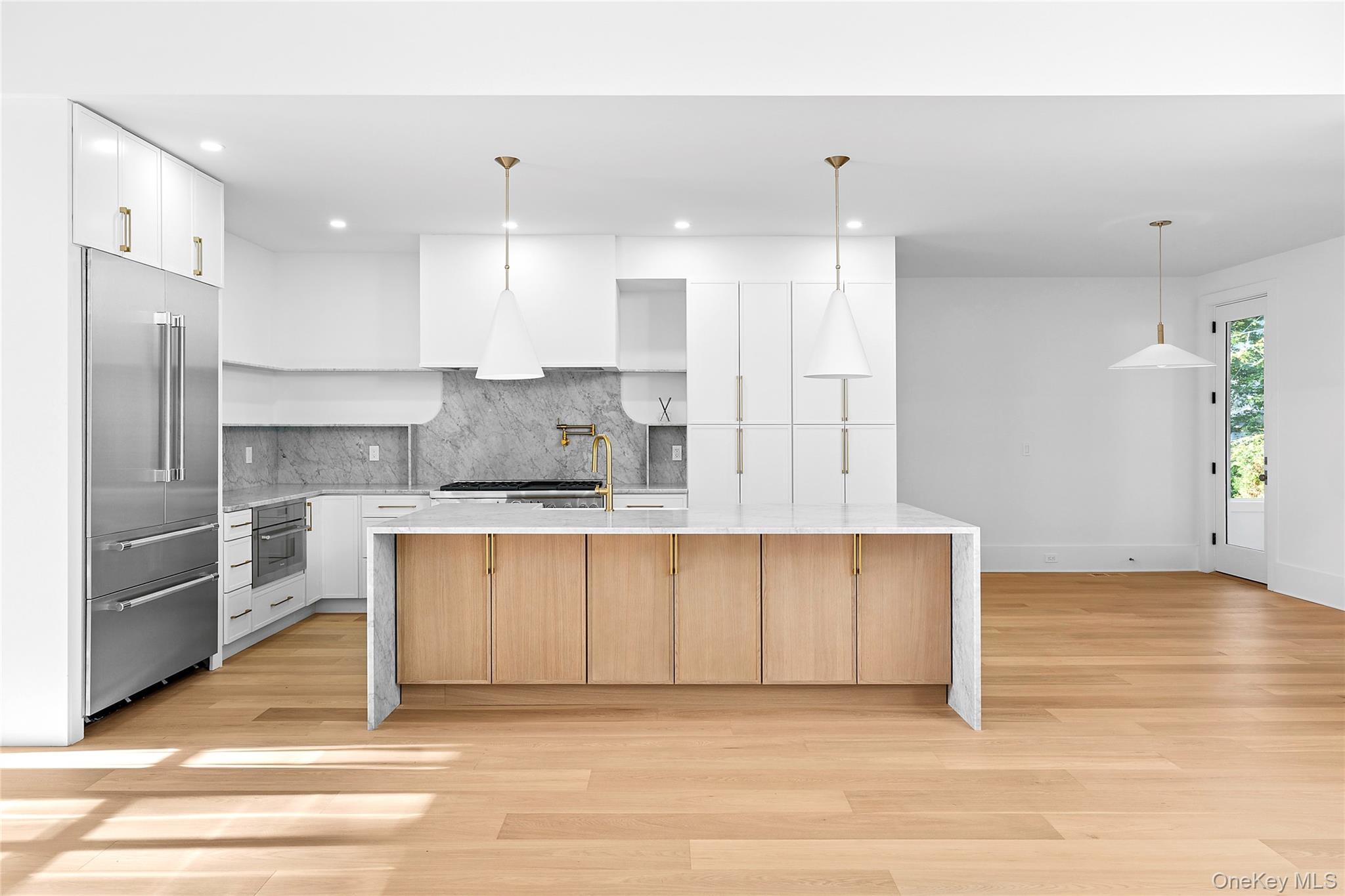 5697 Westphalia Road Mattituck, NY 11952 - Photo 7 of 28 a large kitchen with kitchen island a sink stainless steel appliances and cabinets