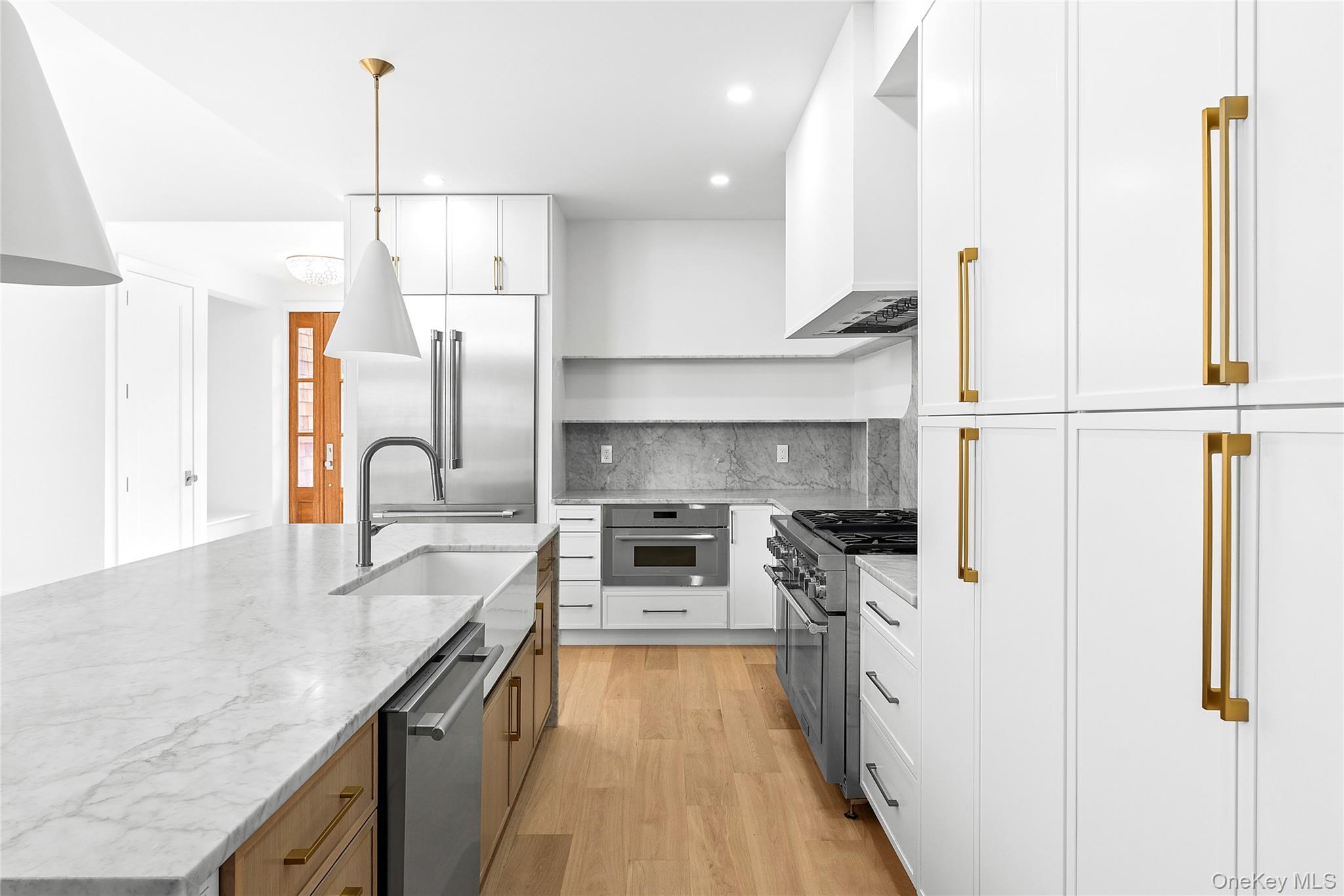 5697 Westphalia Road Mattituck, NY 11952 - Photo 8 of 28 a kitchen with stainless steel appliances granite countertop a sink a stove and a refrigerator