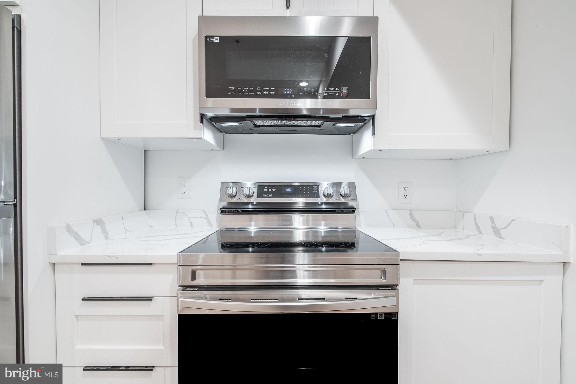 36 Channing Street Northwest, Unit A Washington, DC 20001 - Photo 10 of 33 a stove top oven sitting inside of a kitchen