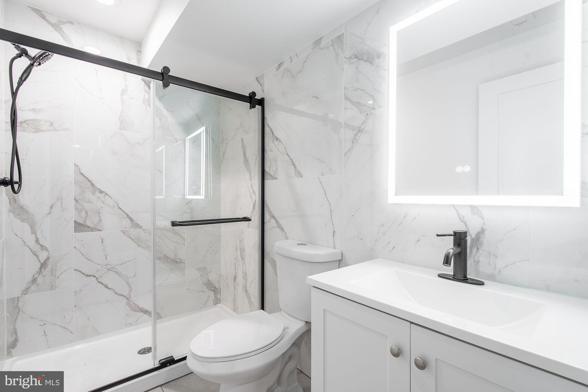 36 Channing Street Northwest, Unit A Washington, DC 20001 - Photo 14 of 33 a bathroom with a sink a toilet and a shower