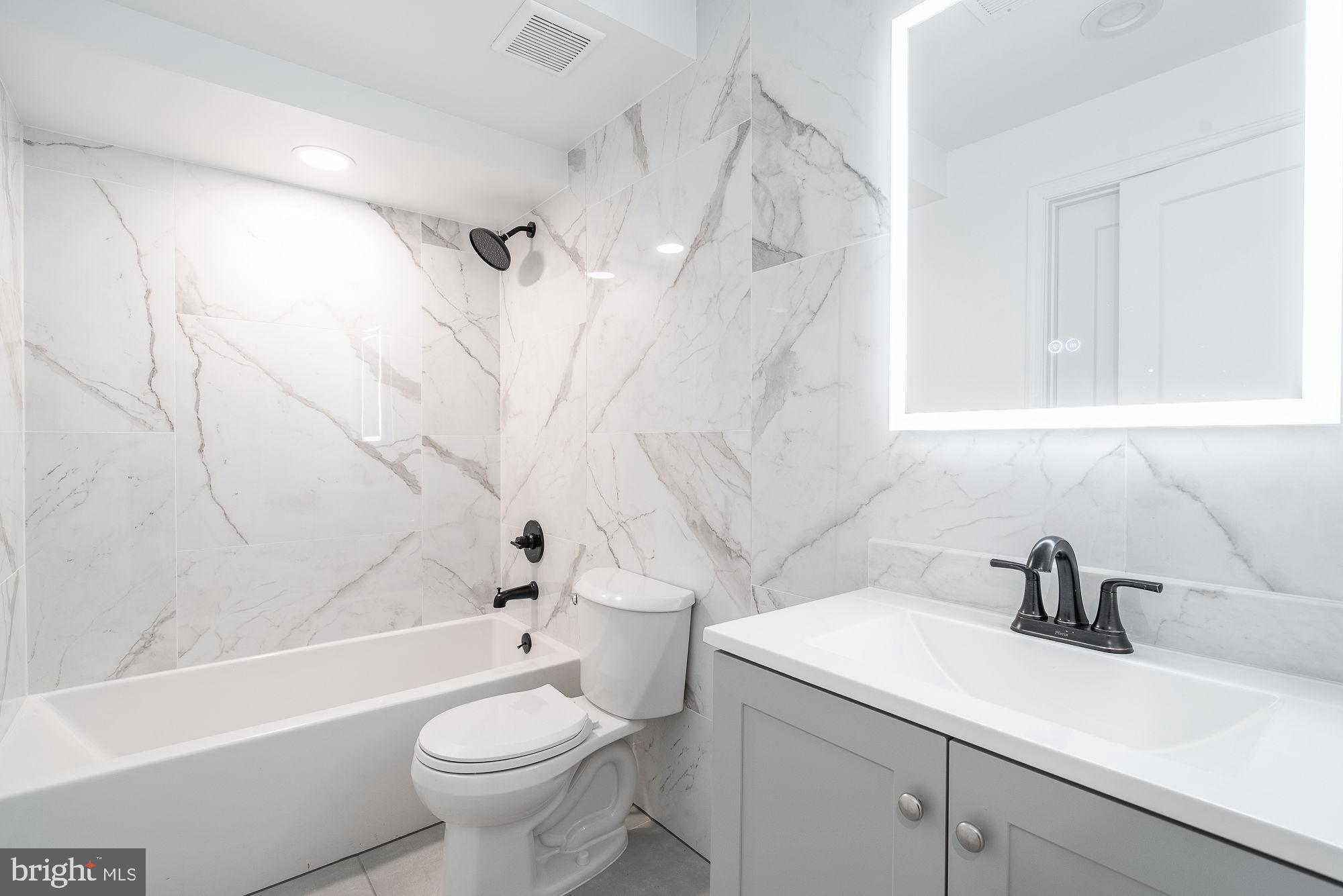 36 Channing Street Northwest, Unit A Washington, DC 20001 - Photo 15 of 33 a bathroom with a sink a toilet and a bathtub