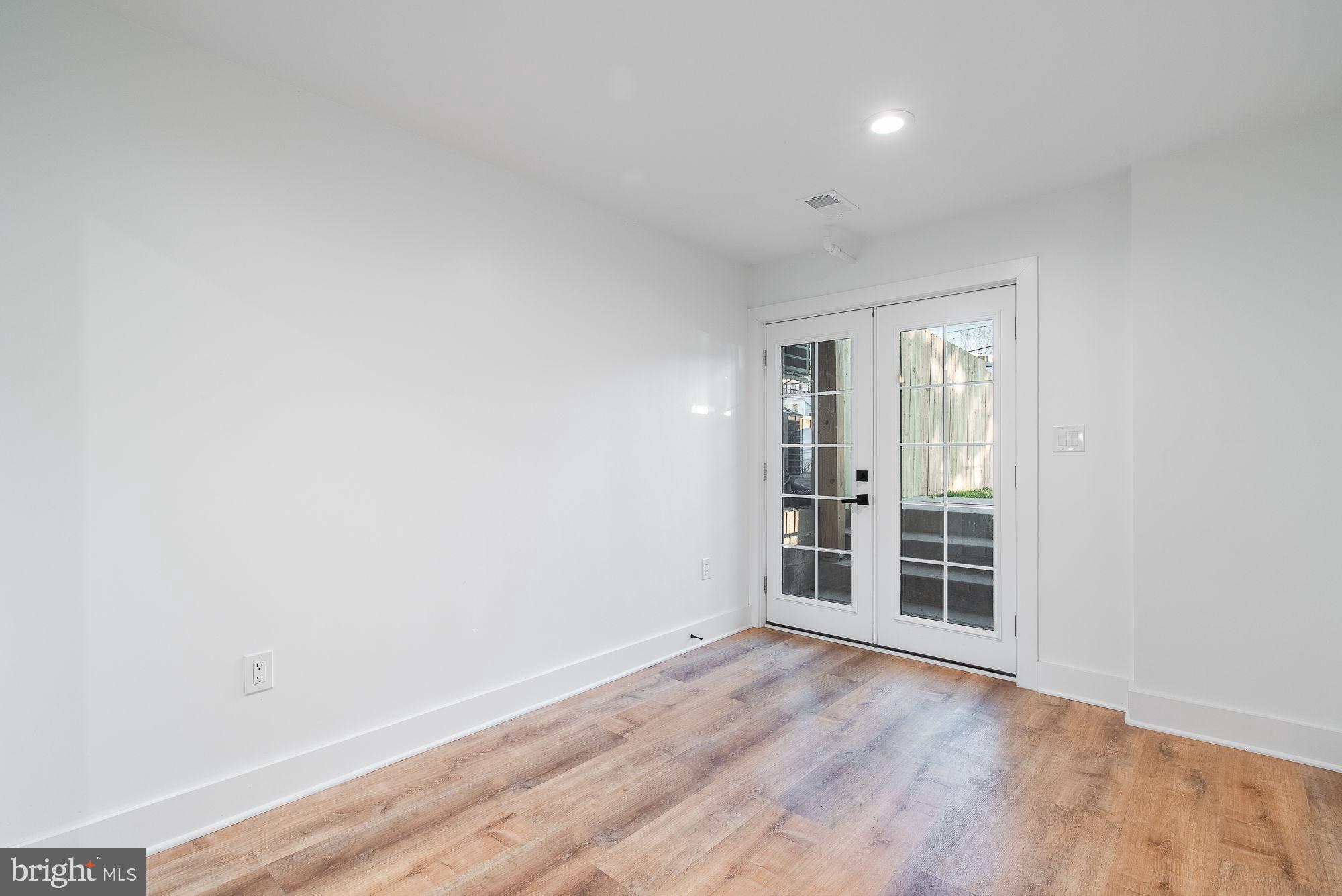 36 Channing Street Northwest, Unit A Washington, DC 20001 - Photo 19 of 33 an empty room with wooden floor and windows