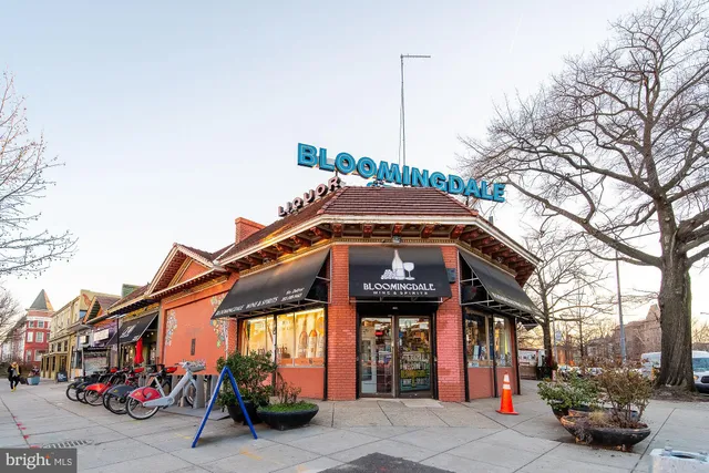 a row of palm trees in front of a building