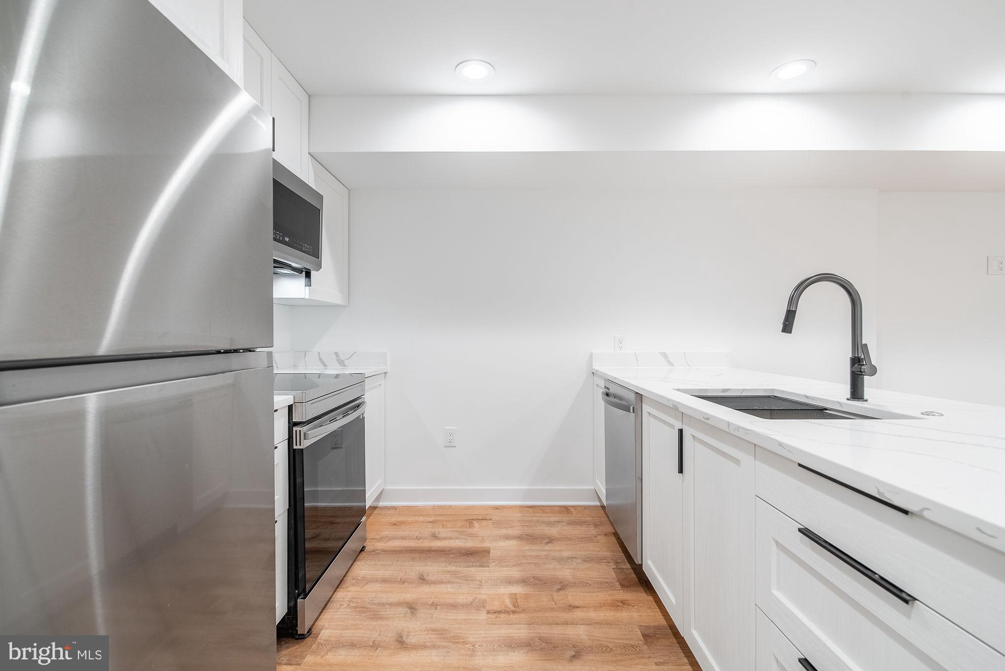 36 Channing Street Northwest, Unit A Washington, DC 20001 - Photo 7 of 33 a kitchen with a refrigerator and a sink