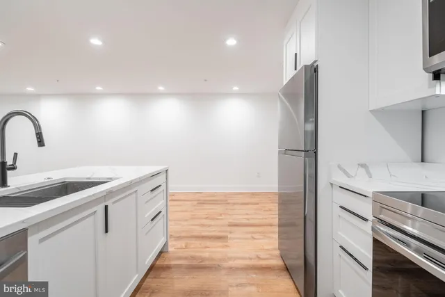 a kitchen with a refrigerator and a sink