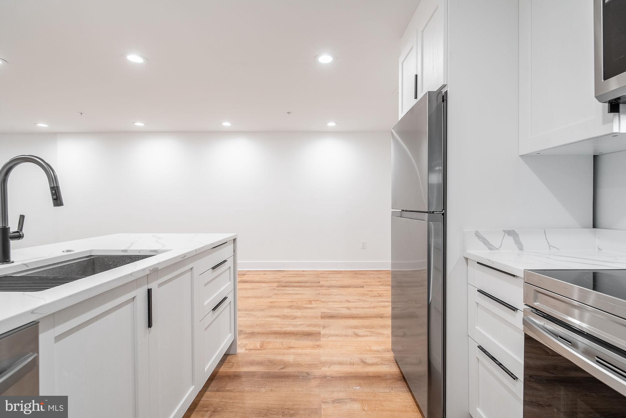 36 Channing Street Northwest, Unit A Washington, DC 20001 - Photo 8 of 33 a kitchen with a sink and refrigerator