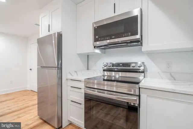 a kitchen with a sink and refrigerator