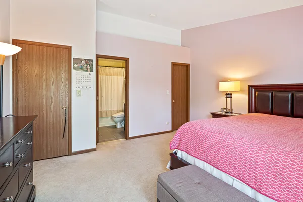 a bedroom with a bed and a closet