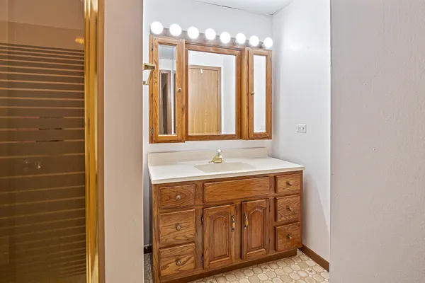 a bathroom with a sink a vanity and a mirror