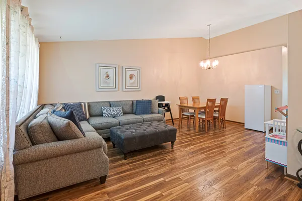 a living room with furniture a flat screen tv and a table