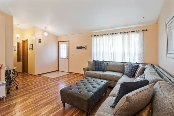 a living room with furniture and wooden floor
