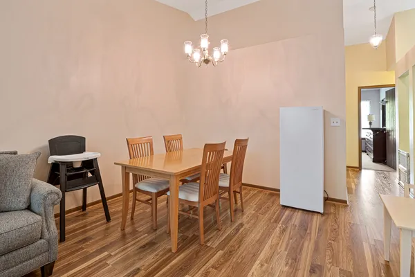 a view of a dining room with furniture and wooden floor