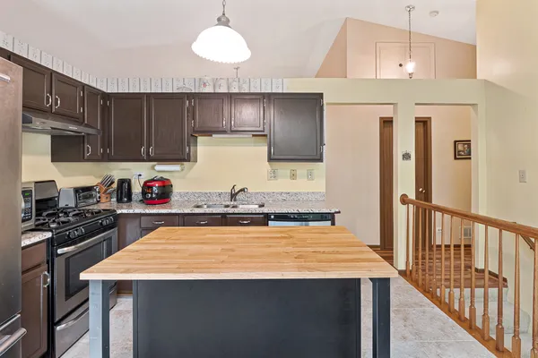 a kitchen with a stove a sink and a refrigerator