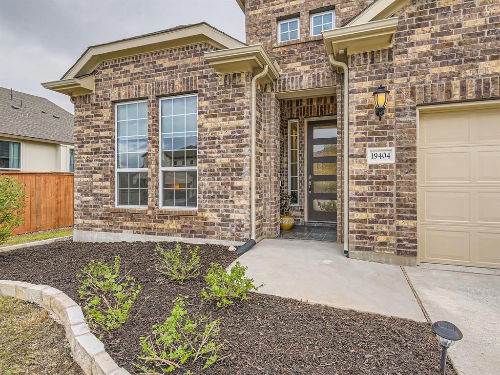front view of a brick house with a large window