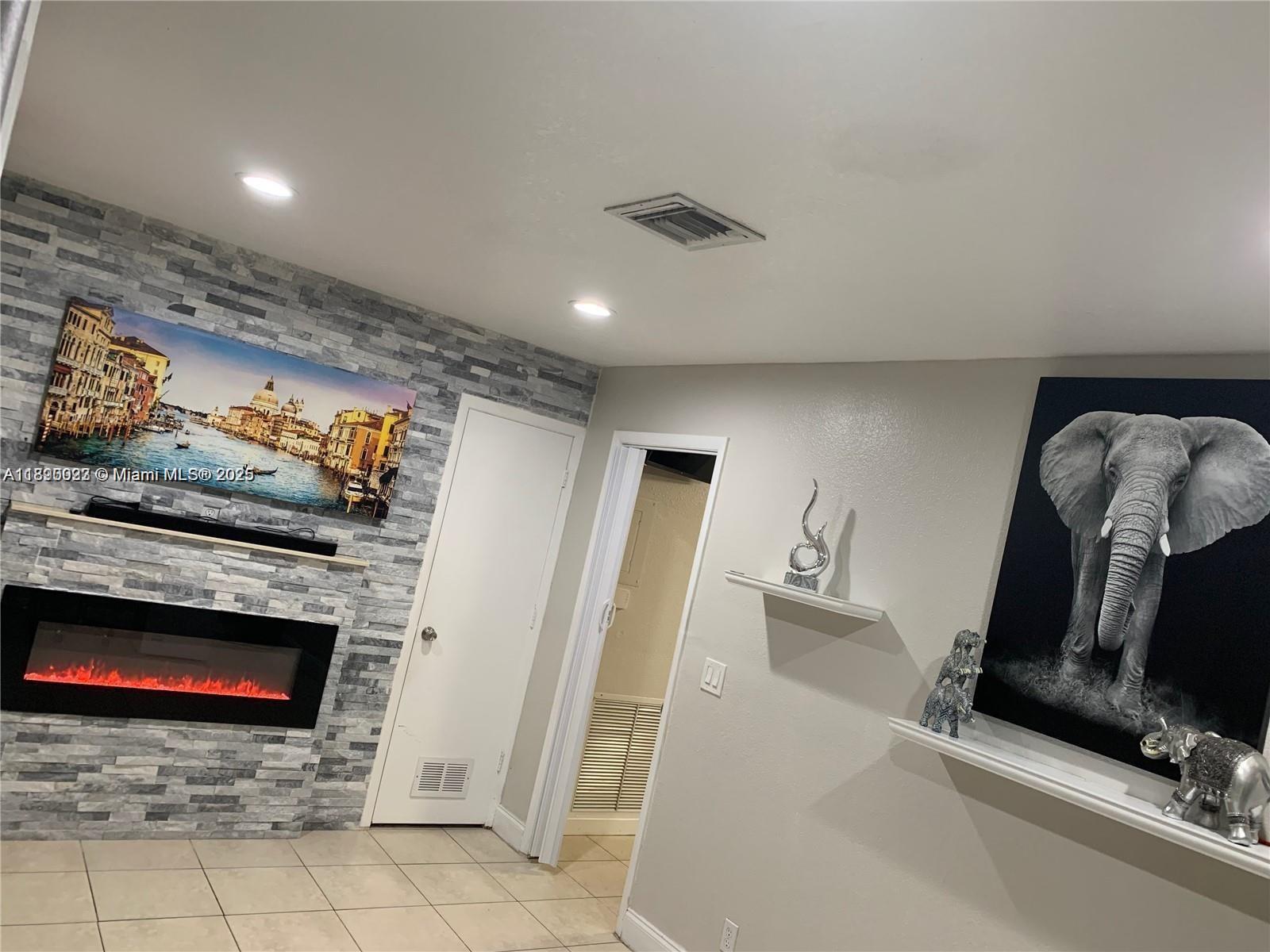 6309 Wiley Street Hollywood, FL 33023 - Photo 3 of 9 a view of a livingroom with furniture and a fireplace