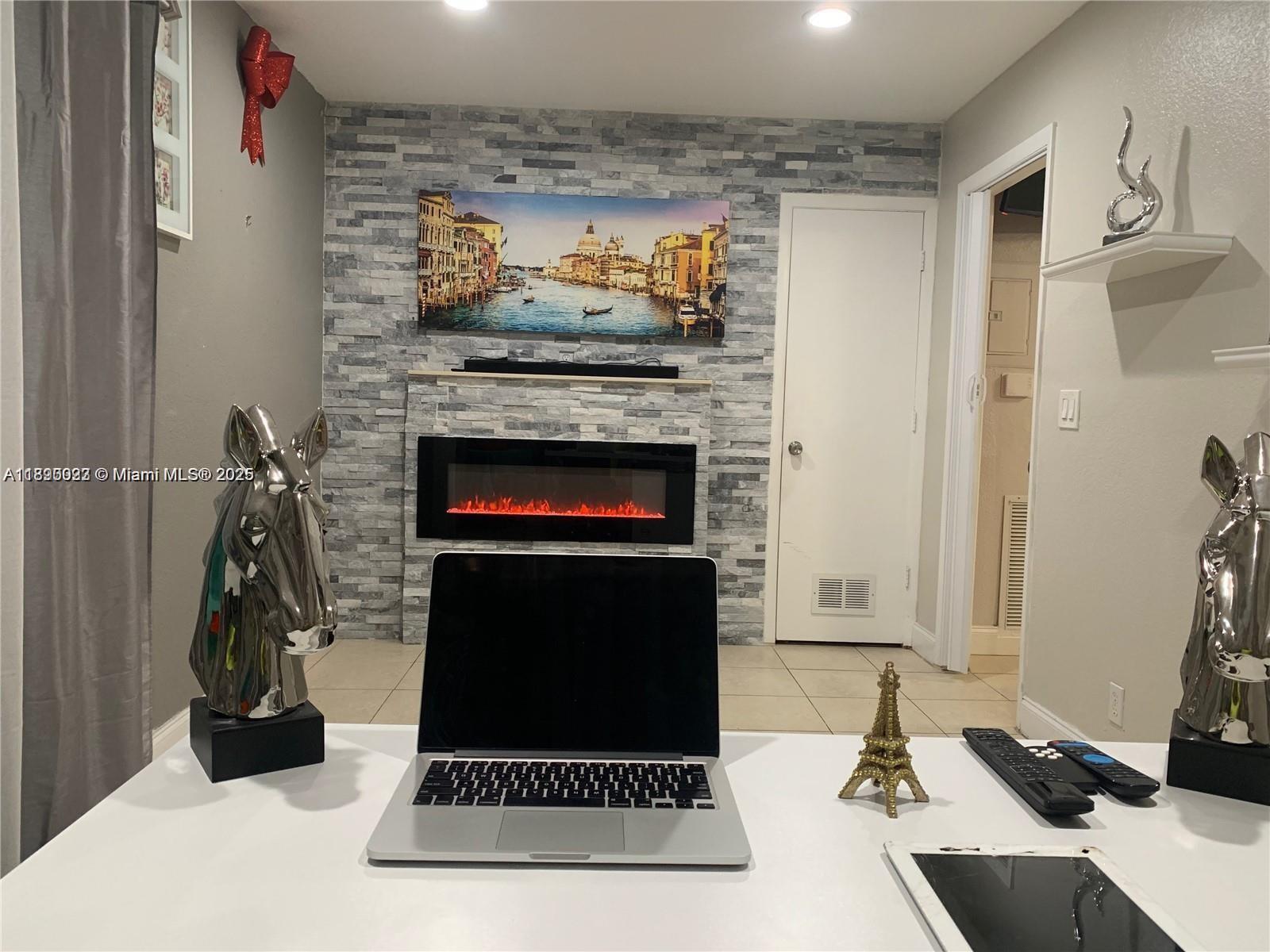 6309 Wiley Street Hollywood, FL 33023 - Photo 5 of 9 a living room with furniture and a fireplace