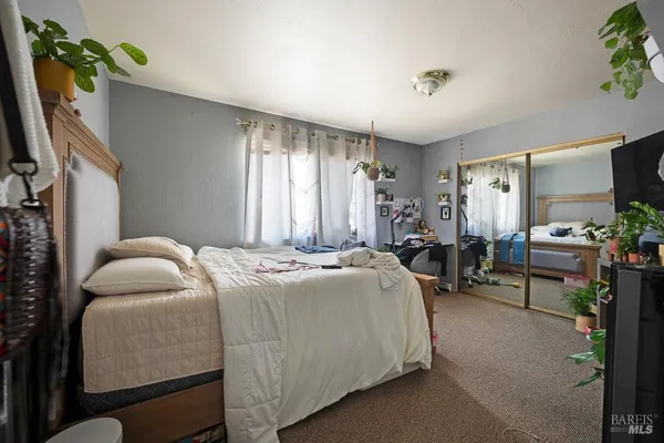 a bedroom with furniture and a flat screen tv