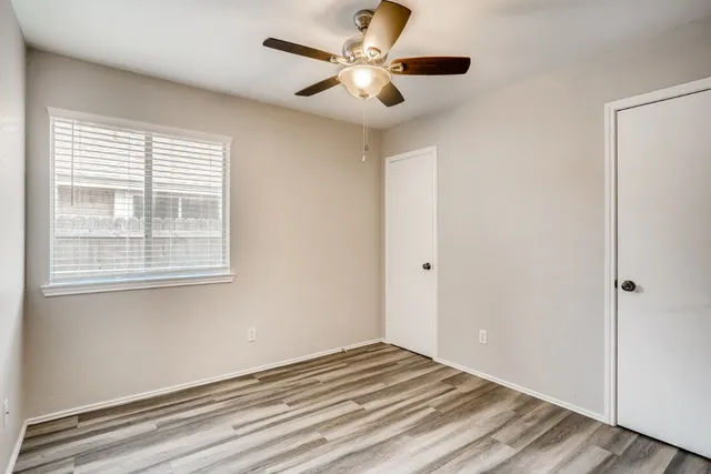 a view of a livingroom with a ceiling fan and window