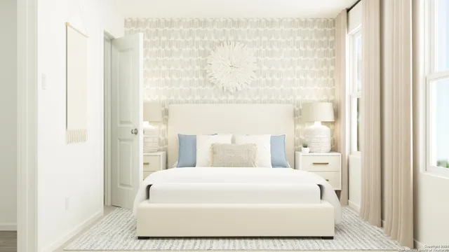 a large white bed sitting in a bathroom next to a window