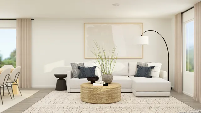 a living room with furniture and a potted plant