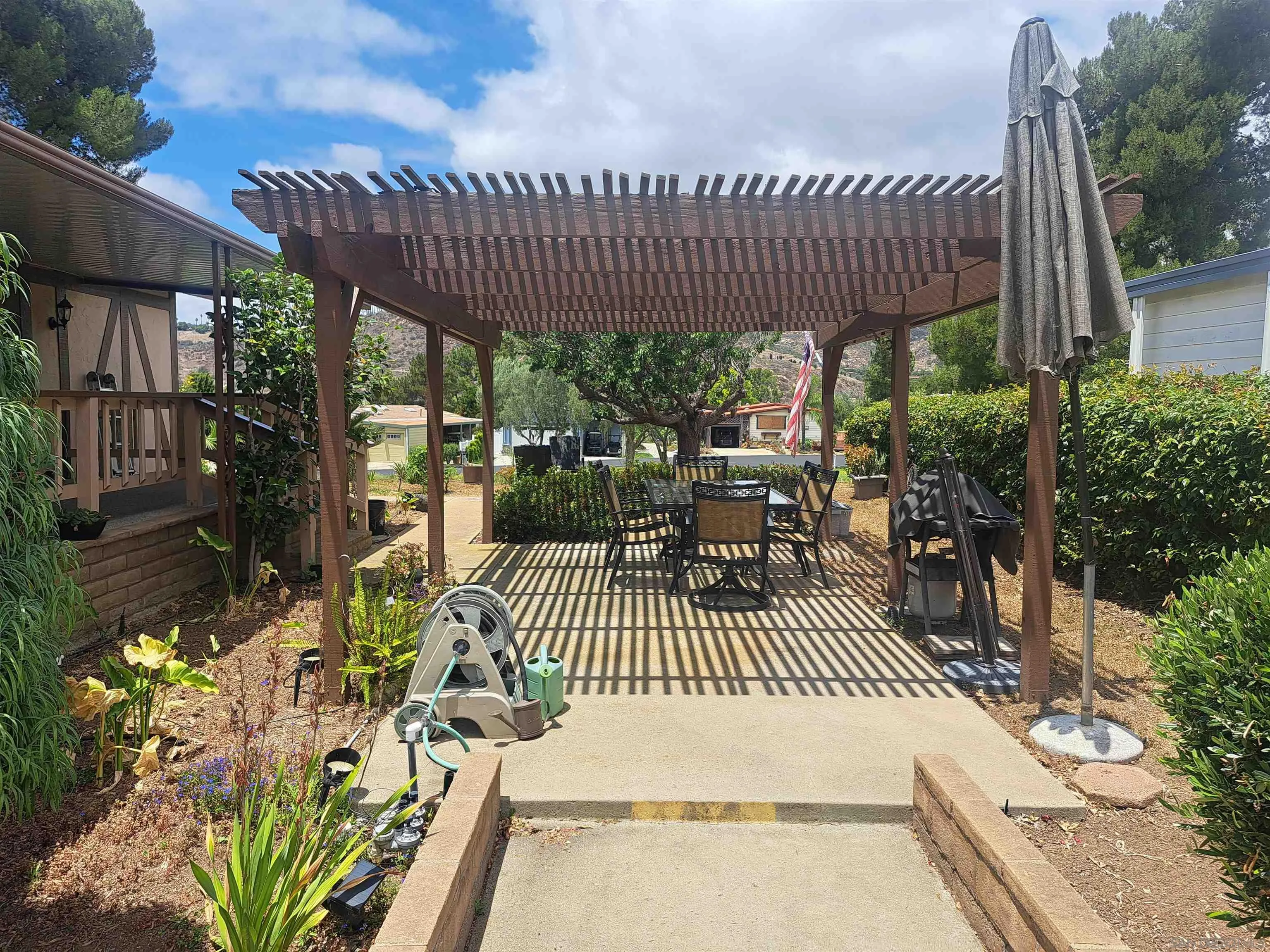 4650 Dulin Road, Unit 12 Fallbrook, CA 92003 - Photo 8 of 36 a view of a patio with table and chairs and potted plants