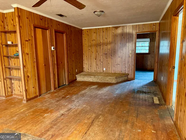 a view of a room with wooden floor and stairs