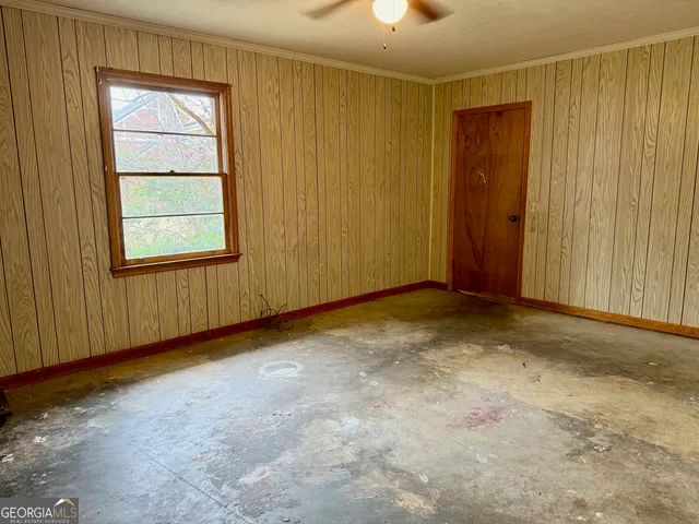 an empty room with windows and closet