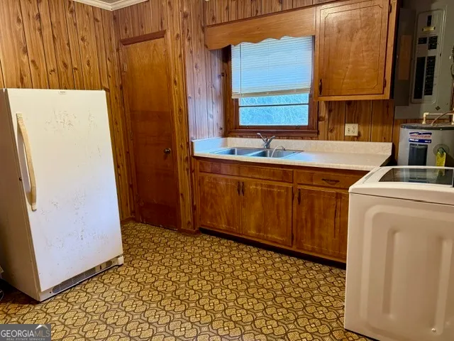a utility room with a sink a washer and dryer