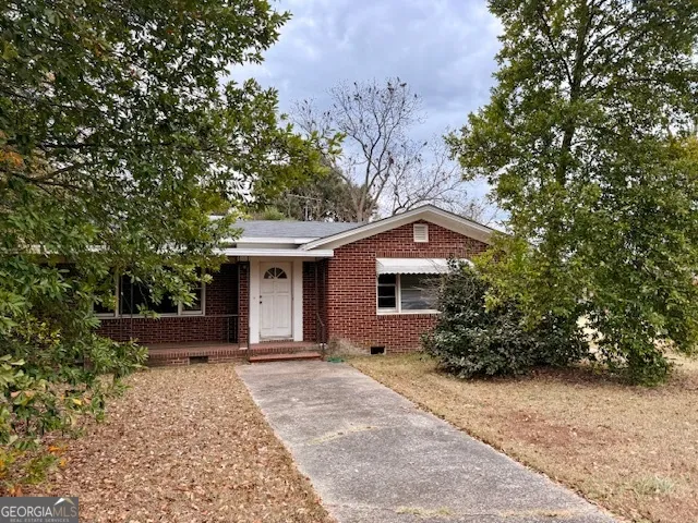 a house with trees in the background
