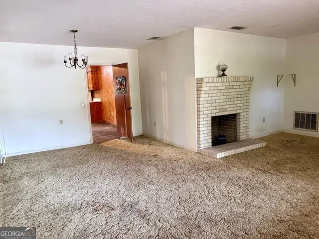 a view of empty room with fireplace