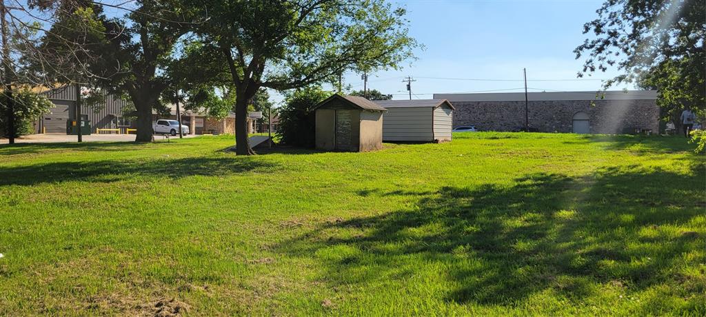 209 East 1st Street Springtown, TX 76082 - Photo 3 of 9 a view of a backyard with large trees