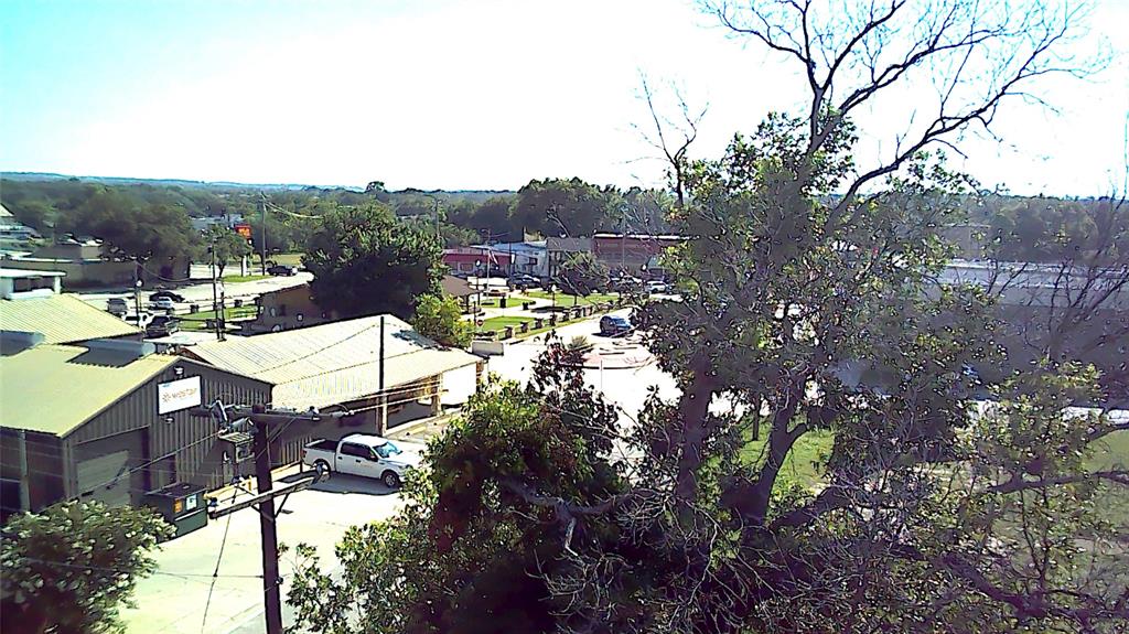 209 East 1st Street Springtown, TX 76082 - Photo 4 of 9 a view of a patio with table and chairs and potted plants