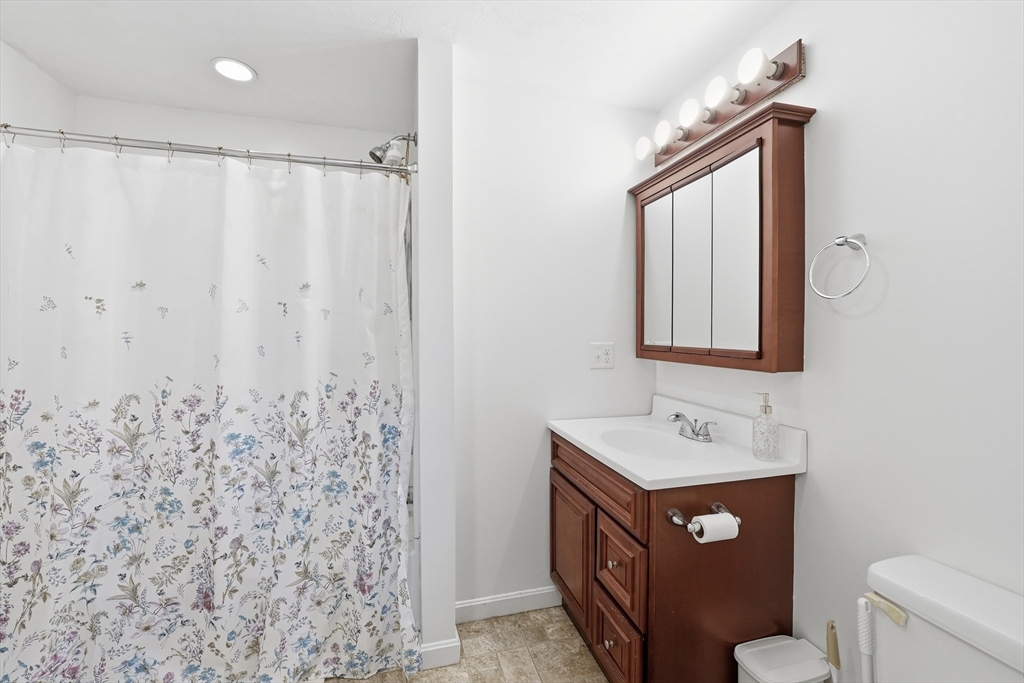 5 Swan Avenue, Unit B Worcester, MA 01602 - Photo 11 of 25 a bathroom with a sink a toilet and a mirror