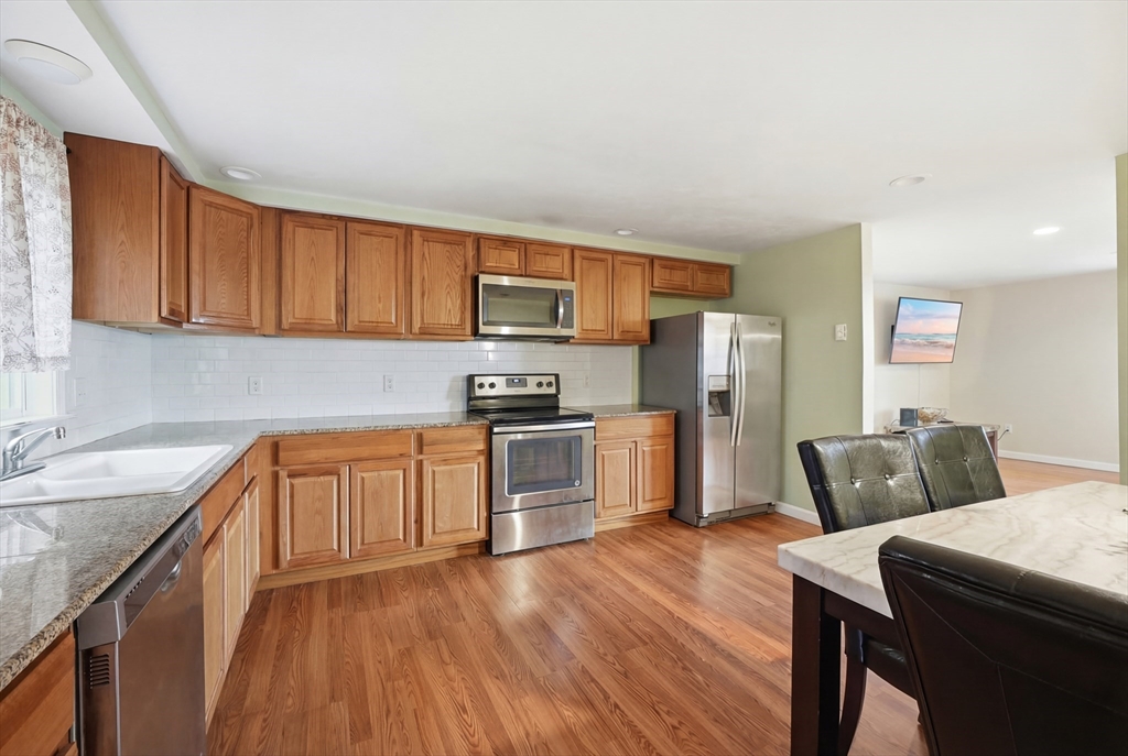5 Swan Avenue, Unit B Worcester, MA 01602 - Photo 7 of 25 a kitchen with stainless steel appliances granite countertop a refrigerator sink and microwave